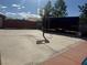 Spacious backyard featuring a basketball hoop and ample concrete space, perfect for outdoor activities at 6248 Sapporo Cir, Las Vegas, NV 89110