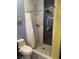 Beautiful bathroom shower with eye-catching tiling, stone flooring, and glass shelf at 6248 Sapporo Cir, Las Vegas, NV 89110