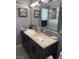 Bathroom with a double sink vanity with marble countertop, dual mirrors, and decorative tile flooring at 6248 Sapporo Cir, Las Vegas, NV 89110