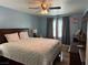Comfortable bedroom featuring a large bed, ceiling fan, and classic decor at 6248 Sapporo Cir, Las Vegas, NV 89110
