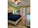 Stylish bedroom featuring a tufted headboard bed, wood floors, and natural lighting at 6248 Sapporo Cir, Las Vegas, NV 89110