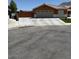 Inviting single-story home with a spacious driveway and well-maintained front yard at 6248 Sapporo Cir, Las Vegas, NV 89110