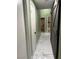 Hallway with marble tile flooring, with a barn door to the right, and open bathroom at the end at 6248 Sapporo Cir, Las Vegas, NV 89110
