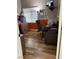 Bedroom-converted office with wooden laminate floors, window blinds, and office furniture at 6248 Sapporo Cir, Las Vegas, NV 89110