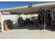 Cozy covered patio with an outdoor kitchen, comfortable seating, and a workout space at 6248 Sapporo Cir, Las Vegas, NV 89110