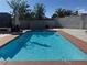 Sparkling in-ground pool with lush landscaping providing privacy in the backyard at 6248 Sapporo Cir, Las Vegas, NV 89110