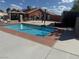 Beautiful in-ground pool with a red brick edge, and the house in the background at 6248 Sapporo Cir, Las Vegas, NV 89110