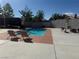 Inviting in-ground pool with two chairs on the patio, with the house in the background at 6248 Sapporo Cir, Las Vegas, NV 89110