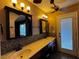 A bathroom featuring double sinks, modern lighting fixtures, and a door to the outside at 6421 Doby Peak Dr, Las Vegas, NV 89108
