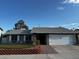 Charming single-story home features a well-maintained front yard and attached two-car garage at 6421 Doby Peak Dr, Las Vegas, NV 89108
