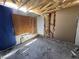 Stripped-down bedroom featuring missing drywall, exposed wood framing, and clear need for restoration at 6723 Oak Valley Dr, Las Vegas, NV 89103