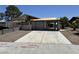 Street view of a distressed single-story house with desert landscaping, a two-car garage, and significant damage needing repair at 6723 Oak Valley Dr, Las Vegas, NV 89103