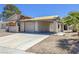 Exterior view of a distressed single-Gathering home with damaged roof and peeling paint at 6723 Oak Valley Dr, Las Vegas, NV 89103