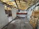 Garage needing repairs and renovations, featuring exposed walls, incomplete framing, and a concrete floor at 6723 Oak Valley Dr, Las Vegas, NV 89103