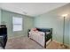 Cozy bedroom with a twin bed, soft lighting, and a calming atmosphere at 6940 Crescent Gold St, North Las Vegas, NV 89086