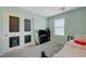 Bright bedroom with painted chalkboard closet doors, window with blinds, and cozy furnishings at 6940 Crescent Gold St, North Las Vegas, NV 89086