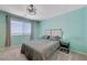 Well-lit bedroom with modern decor, a large window, and plush carpeting at 6940 Crescent Gold St, North Las Vegas, NV 89086