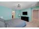 Spacious bedroom featuring modern decor, a flat screen TV, and ensuite bathroom access at 6940 Crescent Gold St, North Las Vegas, NV 89086