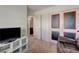 Bedroom view with a comfortable chair, chalkboard doors, and a view to the bathroom at 6940 Crescent Gold St, North Las Vegas, NV 89086