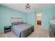 Stylish bedroom with a ceiling fan, soft carpet, and modern decor at 6940 Crescent Gold St, North Las Vegas, NV 89086
