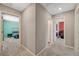 Bright hallway featuring neutral walls with doorways leading to various rooms and spaces at 6940 Crescent Gold St, North Las Vegas, NV 89086
