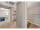 Hallway with a laundry area and a view of the toilet room on the right at 6940 Crescent Gold St, North Las Vegas, NV 89086