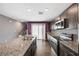 Bright kitchen featuring an island, stainless steel appliances, and modern cabinetry at 6940 Crescent Gold St, North Las Vegas, NV 89086