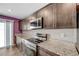 Modern kitchen features a large cooktop, stainless appliances, and granite countertops at 6940 Crescent Gold St, North Las Vegas, NV 89086