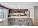 Bright, open-concept kitchen with granite island, stainless appliances, and sliding door at 6940 Crescent Gold St, North Las Vegas, NV 89086