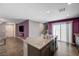 Modern kitchen featuring a large island and a view of the living room at 6940 Crescent Gold St, North Las Vegas, NV 89086