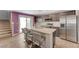 Modern kitchen featuring a large island, stainless steel appliances, and ample cabinetry at 6940 Crescent Gold St, North Las Vegas, NV 89086