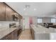 Modern kitchen with stainless steel appliances and an open layout to dining and living areas at 6940 Crescent Gold St, North Las Vegas, NV 89086