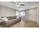 Cozy living room with wood flooring, gray sofa, and bright natural light at 6940 Crescent Gold St, North Las Vegas, NV 89086
