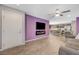 Open-concept living room with modern gray sofa, dining area and kitchen with stainless steel appliances at 6940 Crescent Gold St, North Las Vegas, NV 89086