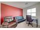 Office space featuring a desk, leather chair and couch, and a bright window at 6940 Crescent Gold St, North Las Vegas, NV 89086