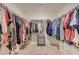 Spacious walk-in closet features rods on both sides and additional shelving for optimal storage and organization at 6940 Crescent Gold St, North Las Vegas, NV 89086