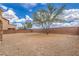Expansive desert landscaping and mature trees create a serene and low-maintenance backyard at 7095 Mountain Den Ave, Las Vegas, NV 89179