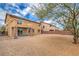 A large, well-maintained backyard features desert landscaping, mature trees, and a covered patio at 7095 Mountain Den Ave, Las Vegas, NV 89179