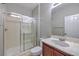 Bathroom with a glass enclosed shower and a sink with mirror and vanity at 7095 Mountain Den Ave, Las Vegas, NV 89179