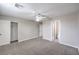 Neutral bedroom with carpet flooring features a ceiling fan and a walk-in closet at 7095 Mountain Den Ave, Las Vegas, NV 89179