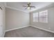The bedroom boasts a ceiling fan and large windows providing plenty of natural light at 7095 Mountain Den Ave, Las Vegas, NV 89179