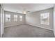 Spacious bedroom with new carpet, a ceiling fan, and multiple windows for natural light at 7095 Mountain Den Ave, Las Vegas, NV 89179