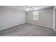 Cozy bedroom with carpet and a window features a double-door closet for extra storage at 7095 Mountain Den Ave, Las Vegas, NV 89179