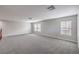 Large, carpeted bonus room has multiple windows that bring in lots of natural light at 7095 Mountain Den Ave, Las Vegas, NV 89179