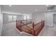 Spacious bonus room features stairs with wood railings and lots of natural light at 7095 Mountain Den Ave, Las Vegas, NV 89179
