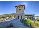 Beautiful stone archway entrance, desert landscaping and architecture under a clear blue sky at 7095 Mountain Den Ave, Las Vegas, NV 89179