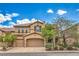 Charming two-story home with a three-car garage, mature landscaping, and a tile roof at 7095 Mountain Den Ave, Las Vegas, NV 89179