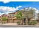 Attractive exterior view of a two-story home with desert landscaping and a three-car garage at 7095 Mountain Den Ave, Las Vegas, NV 89179