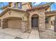 Inviting home exterior featuring a well-maintained lawn, brick accents, and an attached garage at 7095 Mountain Den Ave, Las Vegas, NV 89179