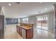 Modern kitchen open to the living area, featuring granite countertops and stainless steel appliances at 7095 Mountain Den Ave, Las Vegas, NV 89179